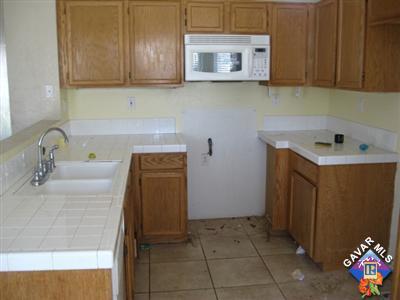 11544 Spring Street Adelanto, CA 92301 - Photo 5 of 15 a kitchen with a sink and cabinets