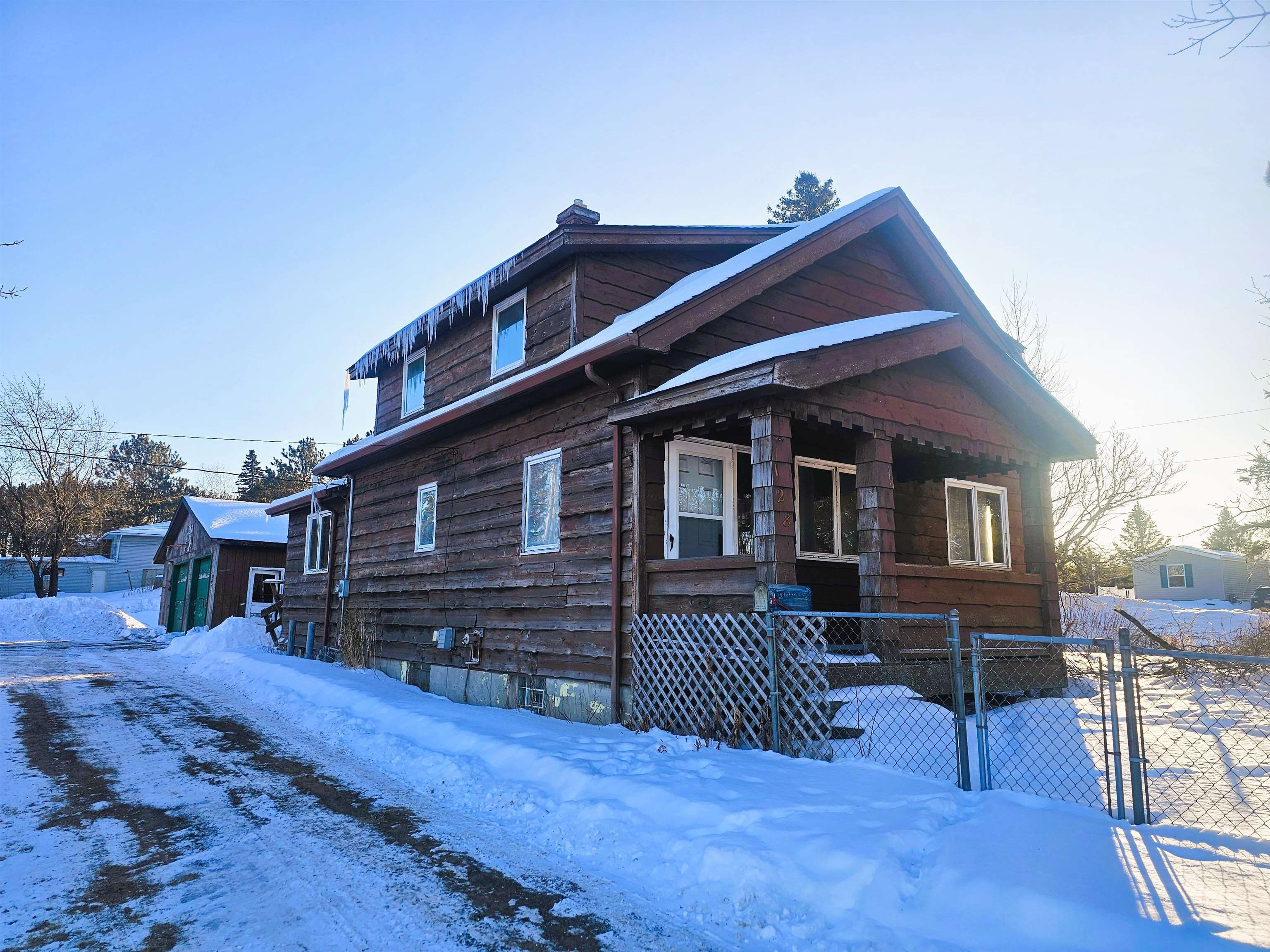View of front of property featuring a gate and fence