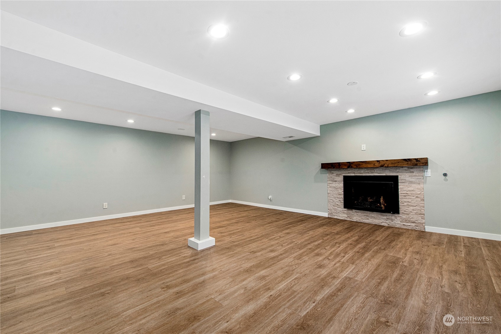 10209 Northeast 198th Street Bothell, WA 98011 - Photo 15 of 28 a view of an empty room with wooden floor fireplace and a window
