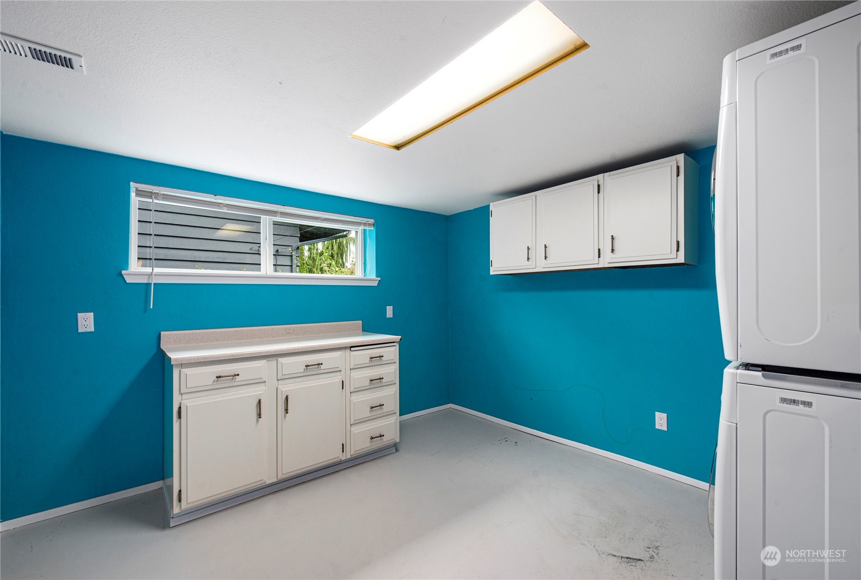 10209 Northeast 198th Street Bothell, WA 98011 - Photo 20 of 28 a room with a white cabinets and a window