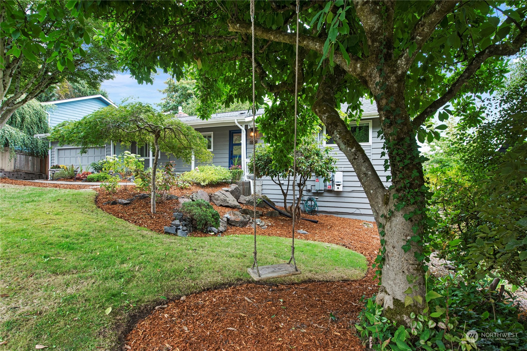 10209 Northeast 198th Street Bothell, WA 98011 - Photo 2 of 28 a view of a patio with table and chairs under an umbrella