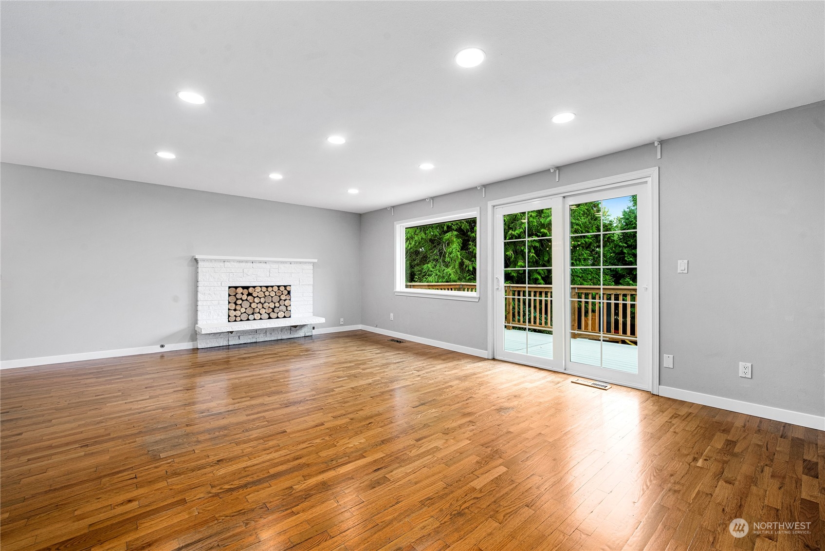 10209 Northeast 198th Street Bothell, WA 98011 - Photo 4 of 28 a view of an empty room with wooden floor and a window