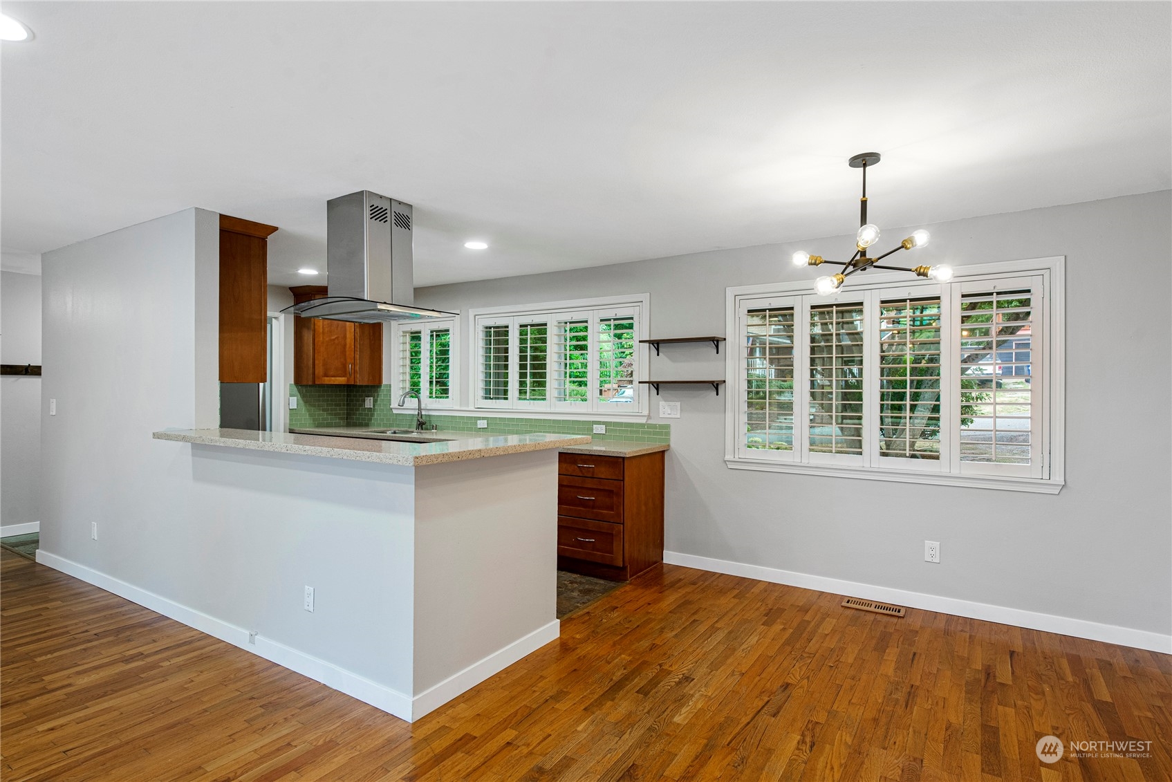 10209 Northeast 198th Street Bothell, WA 98011 - Photo 7 of 28 a kitchen with stainless steel appliances granite countertop a stove and a wooden floors
