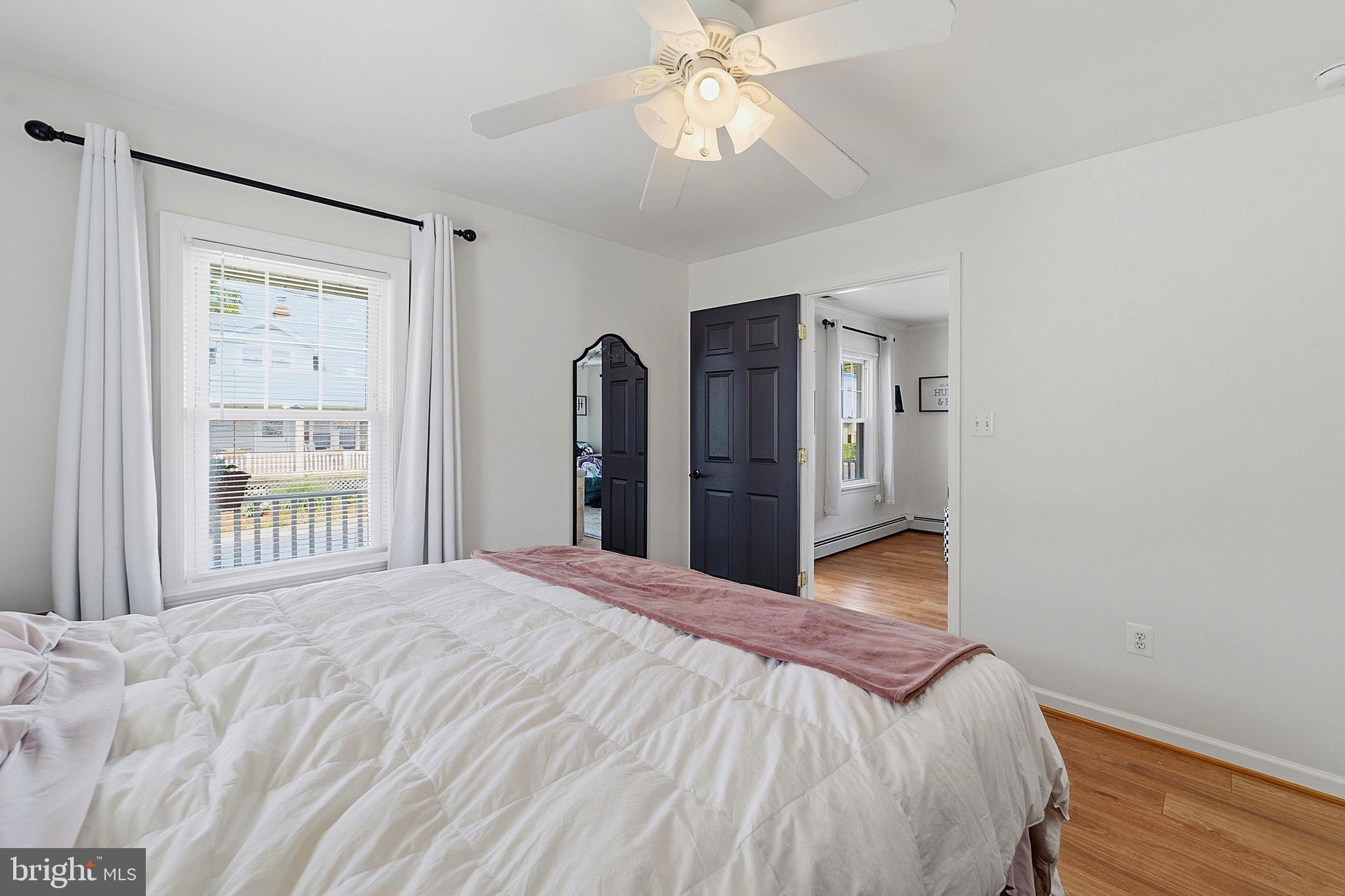 15 South Clinton Avenue Maple Shade, NJ 08052 - Photo 14 of 29 a bedroom with a large bed and a chandelier