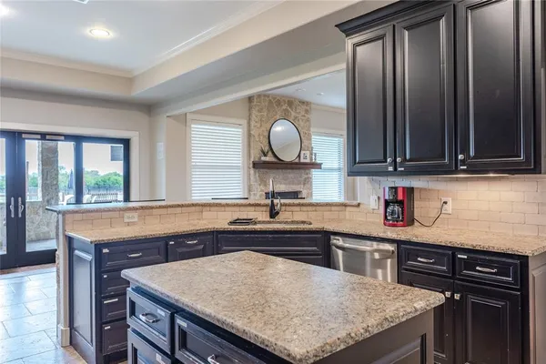 a kitchen with stainless steel appliances granite countertop a stove refrigerator sink and cabinets