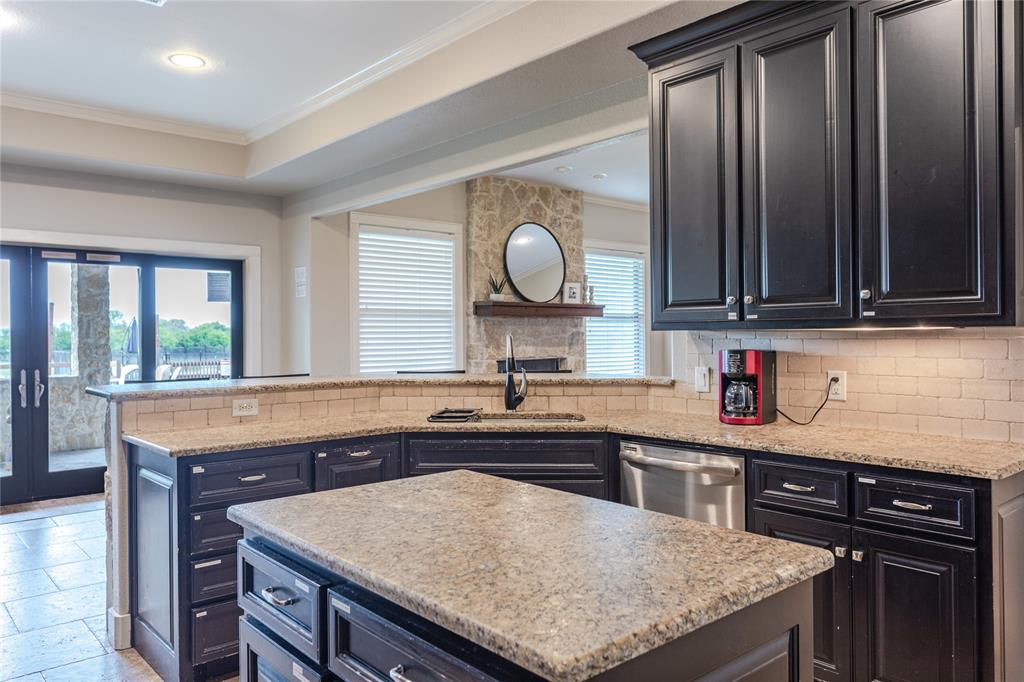 313 Wolf Creek Road Lorena, TX 76655 - Photo 11 of 39 a kitchen with granite countertop a sink a stove and cabinets