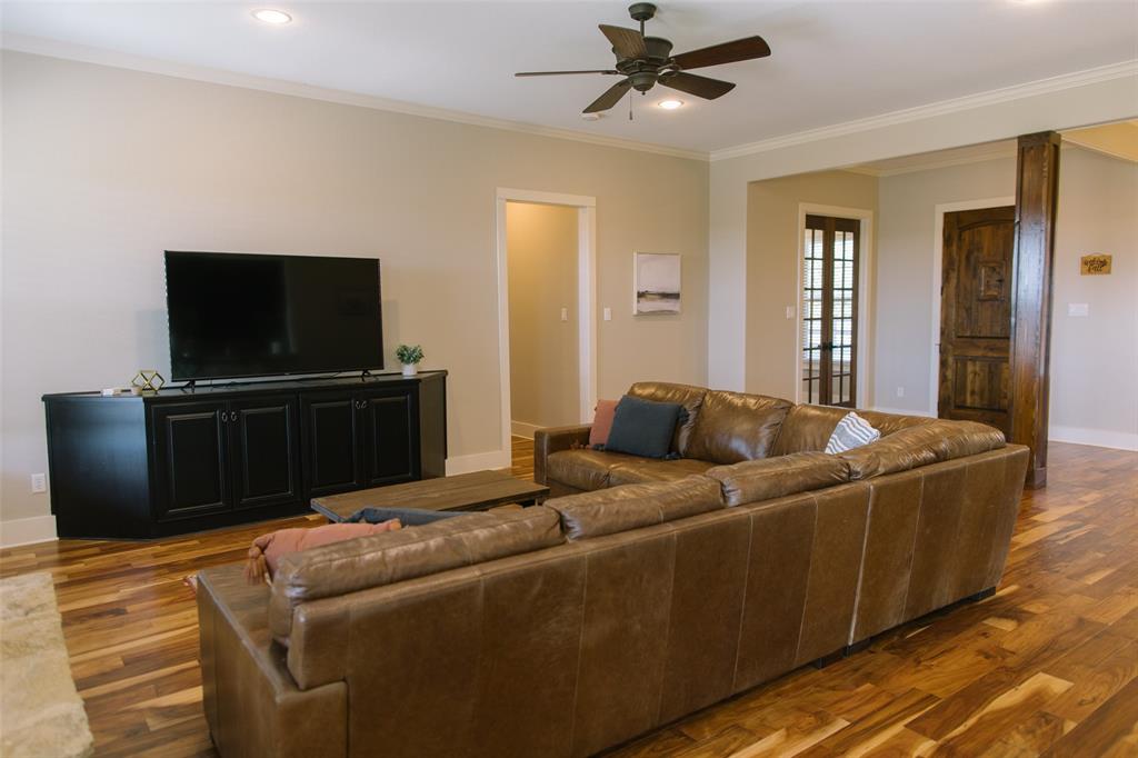 313 Wolf Creek Road Lorena, TX 76655 - Photo 14 of 39 a living room with furniture and a flat screen tv