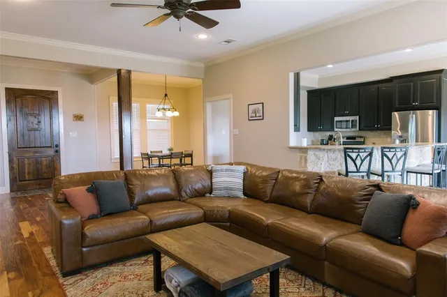 a living room with furniture a fireplace and a window