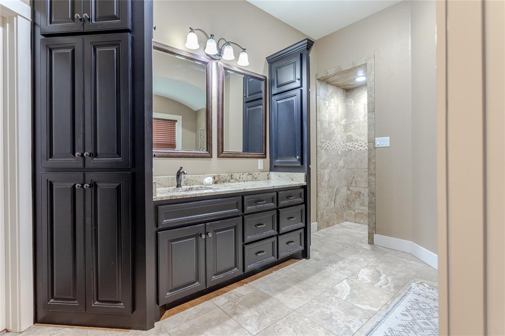 313 Wolf Creek Road Lorena, TX 76655 - Photo 21 of 39 a bathroom with a sink double vanity and a mirror