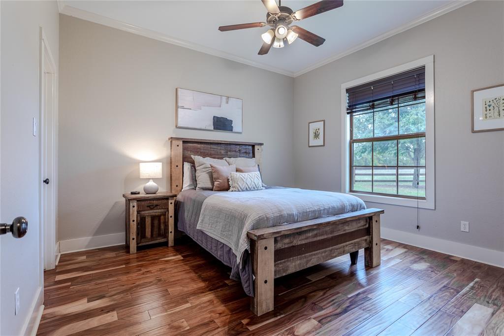 313 Wolf Creek Road Lorena, TX 76655 - Photo 26 of 39 a bed sitting in a bedroom next to a window