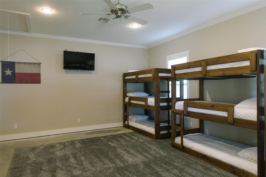 313 Wolf Creek Road Lorena, TX 76655 - Photo 29 of 39 a living room with furniture and a flat screen tv