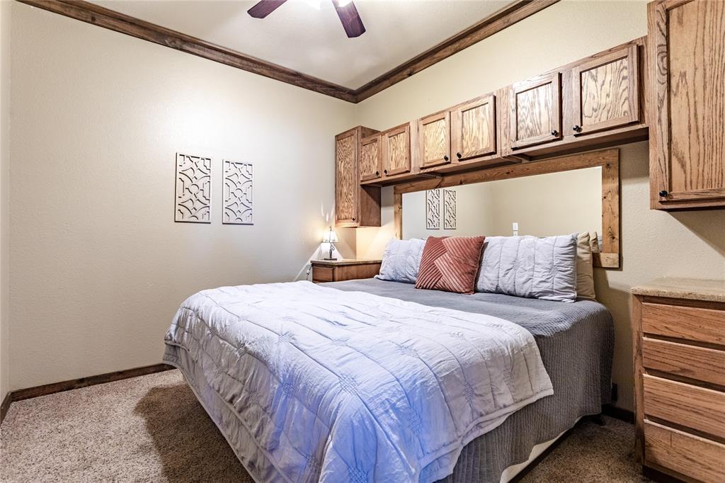 313 Wolf Creek Road Lorena, TX 76655 - Photo 38 of 39 a bedroom with bed and paintings on the wall