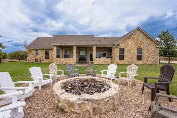 a view of a house with backyard porch and furniture