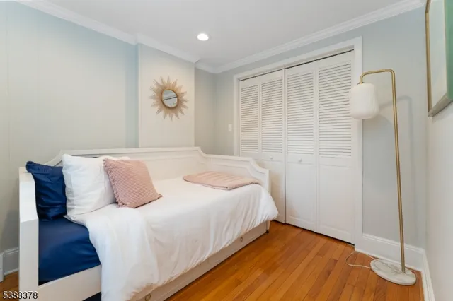 a bedroom with a bed and painting on the wall