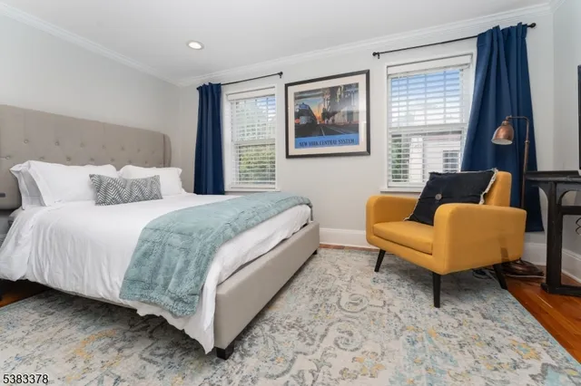 a bedroom with a bed a couch and a window