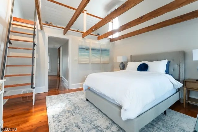 a large bed sitting in a bedroom next to a window