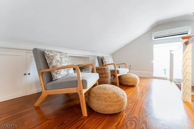 a bedroom with two beds and wooden floor