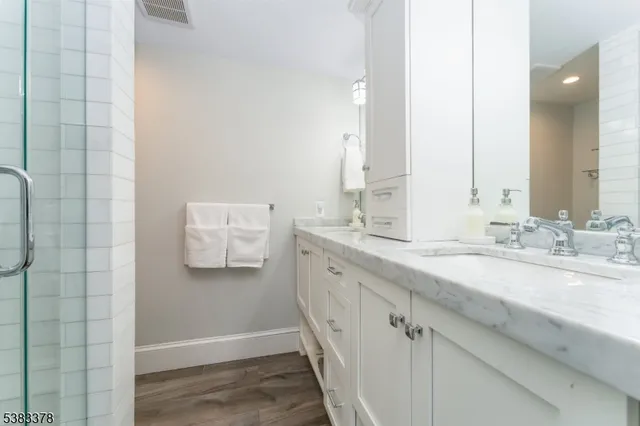 a bathroom with a double vanity sink and mirror