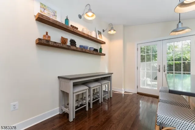 a hallway with wooden floor and staircase