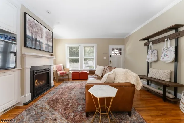 a living room with furniture a fireplace and a table