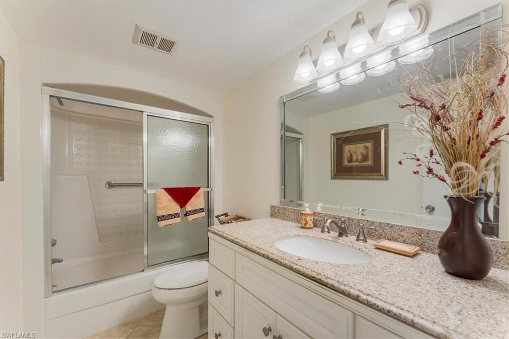 315 St Andrews Boulevard, Unit B32 Naples, FL 34113 - Photo 20 of 27 a bathroom with a granite countertop sink a toilet and shower