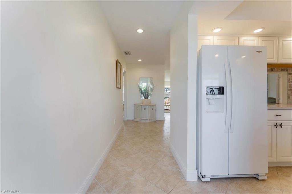 315 St Andrews Boulevard, Unit B32 Naples, FL 34113 - Photo 5 of 27 a view of a hallway with wooden floor and a bathroom