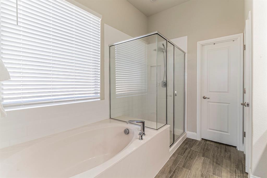 10638 Cherry Tree Way Grand Prairie, TX 76065 - Photo 17 of 39 Primary bathroom facing the garden tub, separate shower, and walk-in closet
