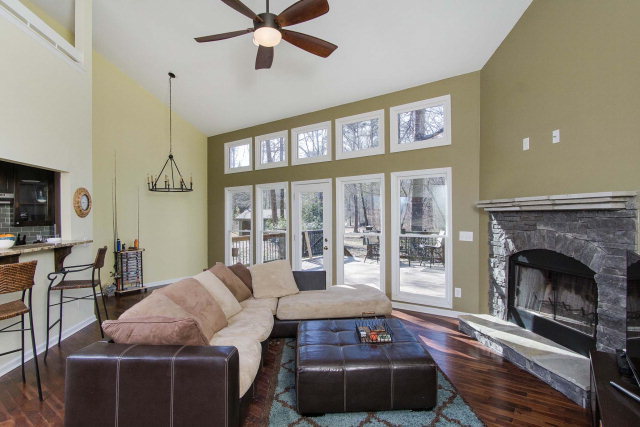 6415 Dobson Road Macon, GA 31220 - Photo 11 of 29 a living room with furniture a fireplace and a floor to ceiling window