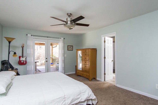 6415 Dobson Road Macon, GA 31220 - Photo 16 of 29 a bedroom with a bed and a chandelier