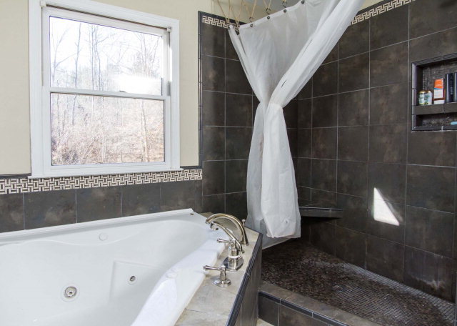 6415 Dobson Road Macon, GA 31220 - Photo 17 of 29 a bathroom with a bathtub and a shower