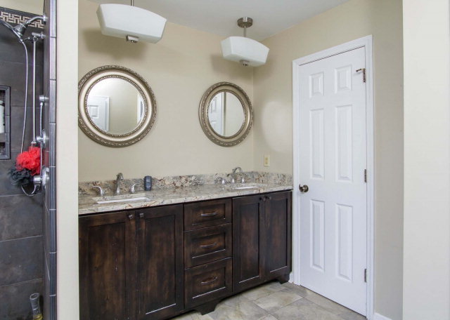 6415 Dobson Road Macon, GA 31220 - Photo 19 of 29 a bathroom with a granite countertop double vanity sink and a mirror