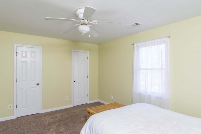 6415 Dobson Road Macon, GA 31220 - Photo 26 of 29 a bedroom with a bed and a chandelier