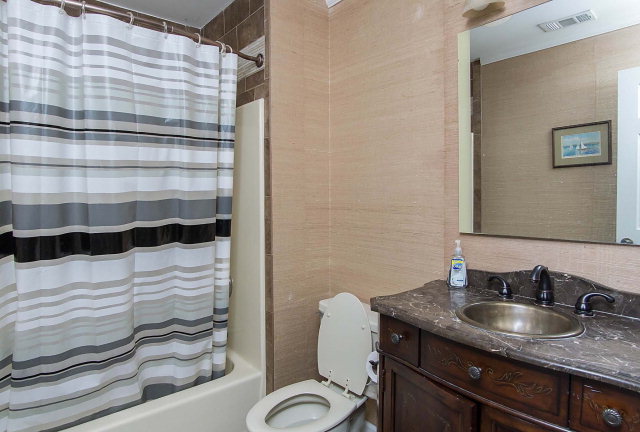 6415 Dobson Road Macon, GA 31220 - Photo 29 of 29 a bathroom with a granite countertop sink a toilet and shower