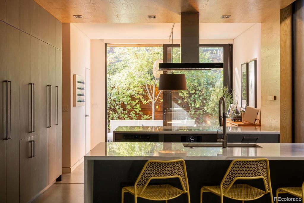 3837 High Street Denver, CO 80205 - Photo 12 of 46 a view of a dining room with furniture window and wooden floor