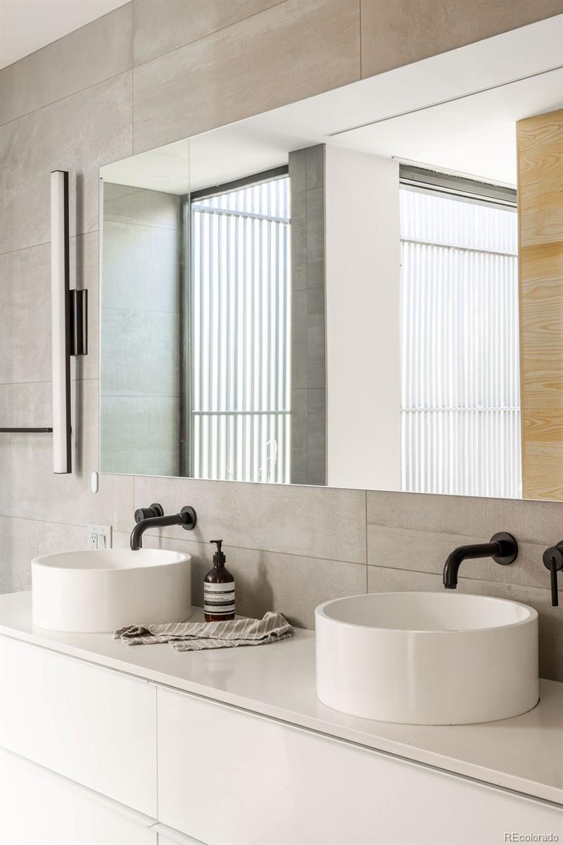 3837 High Street Denver, CO 80205 - Photo 21 of 46 a bathroom with a bathtub a sink and a window