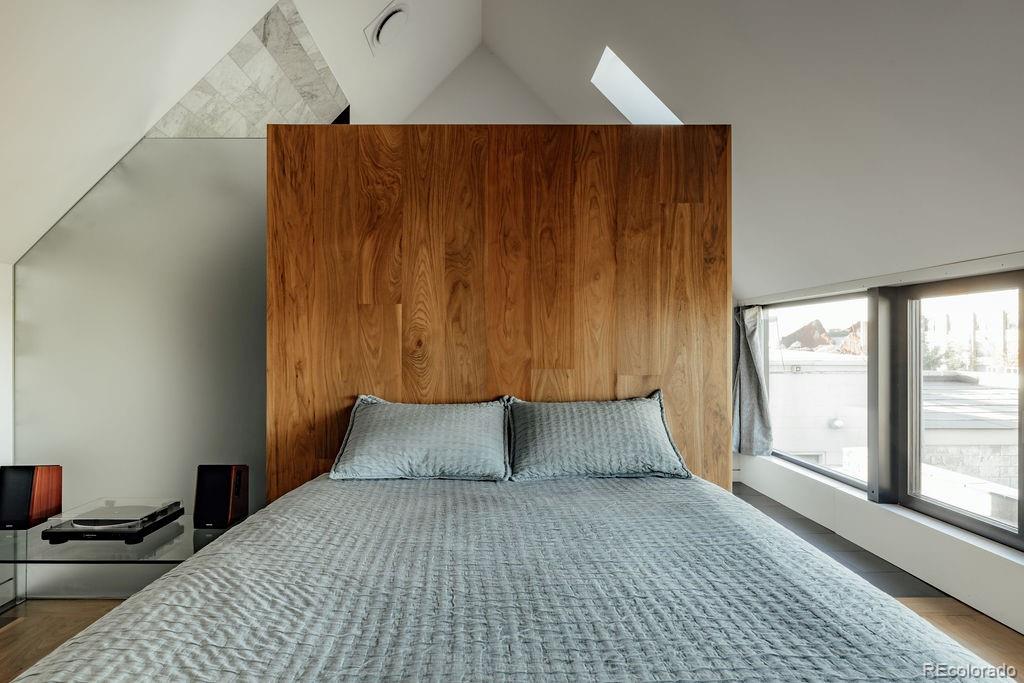 3837 High Street Denver, CO 80205 - Photo 34 of 46 a bedroom with a bed and large window