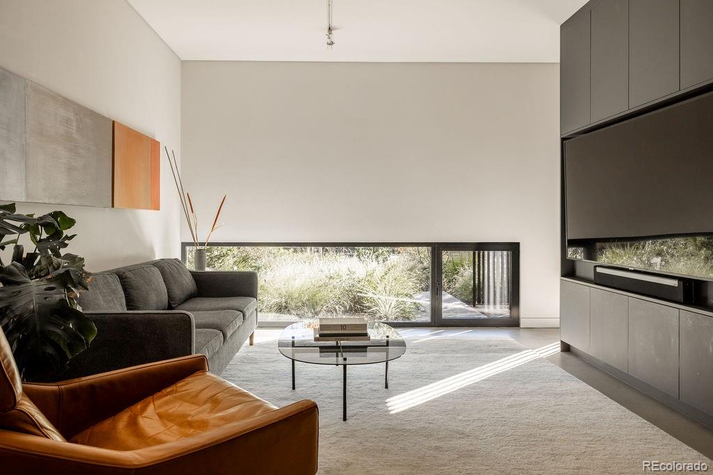 3837 High Street Denver, CO 80205 - Photo 8 of 46 a living room with furniture and a large window