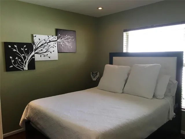 a bed sitting in a bedroom next to a window