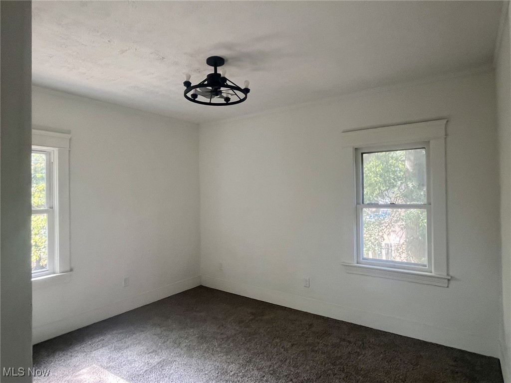 3264 Altamont Road Cleveland, OH 44118 - Photo 15 of 32 Unfurnished room with carpet flooring and a chandelier