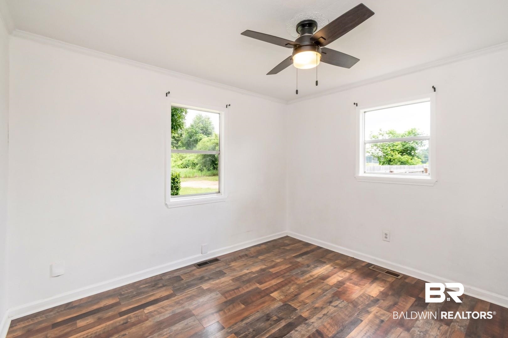 2905A McFarland Road, Unit F Mobile, AL 36695 - Photo 17 of 29 Interior room featuring wood-finish flooring, white walls, and crown molding