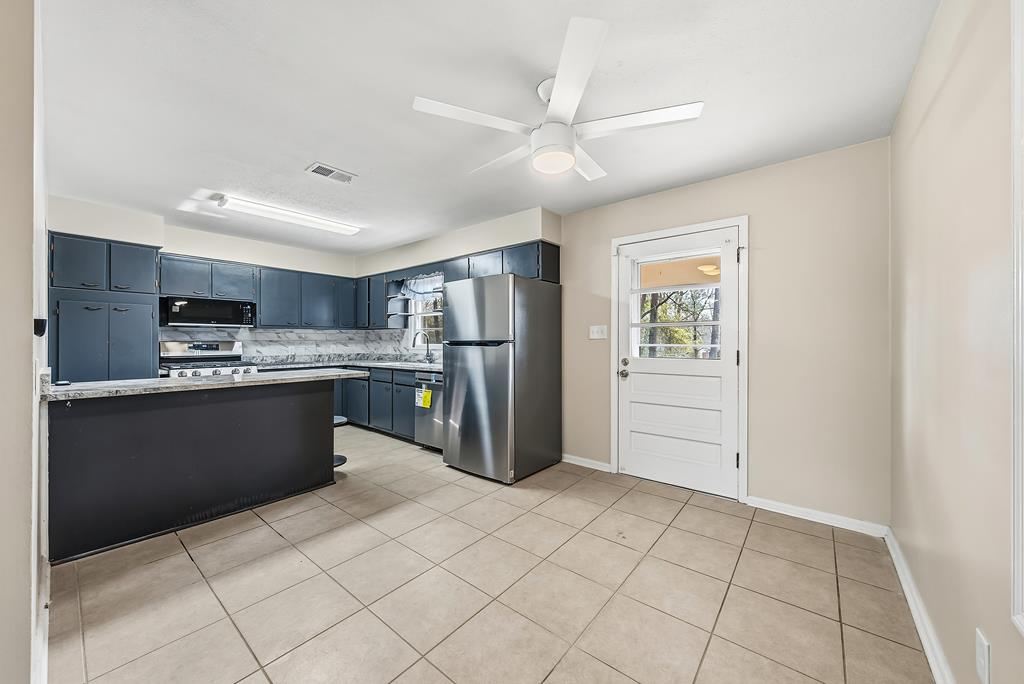 4320 Canady Street Columbus, GA 31909 - Photo 11 of 36 a large kitchen with a large counter top appliances and cabinets