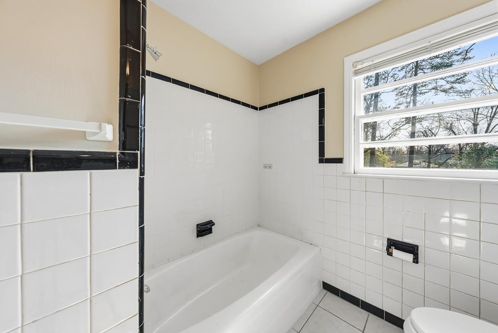 4320 Canady Street Columbus, GA 31909 - Photo 16 of 36 a bathroom with a bathtub and a shower