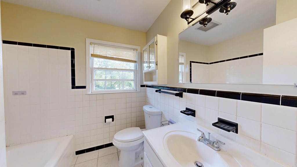 4320 Canady Street Columbus, GA 31909 - Photo 19 of 40 a bathroom with a sink a toilet and shower
