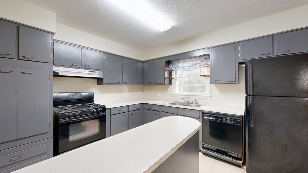 4320 Canady Street Columbus, GA 31909 - Photo 7 of 40 a kitchen with a sink stainless steel appliances and cabinets
