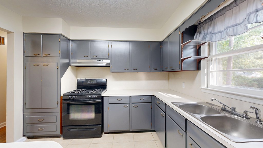 4320 Canady Street Columbus, GA 31909 - Photo 8 of 40 a kitchen with stainless steel appliances granite countertop a sink stove and refrigerator
