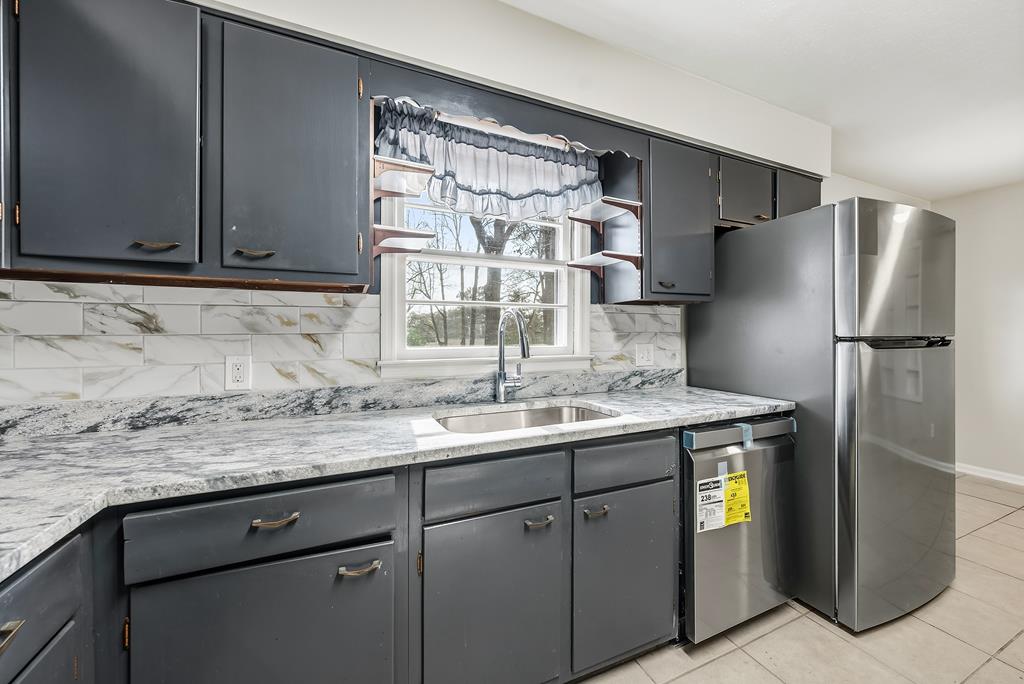 4320 Canady Street Columbus, GA 31909 - Photo 9 of 36 a kitchen with stainless steel appliances granite countertop a sink and a refrigerator