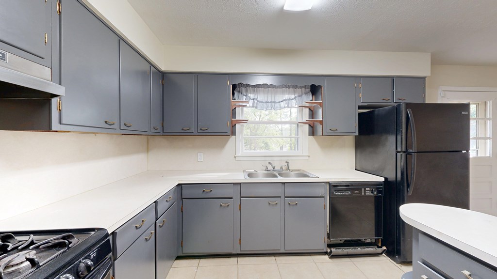 4320 Canady Street Columbus, GA 31909 - Photo 10 of 40 a kitchen with a sink stainless steel appliances a refrigerator and a stove top oven