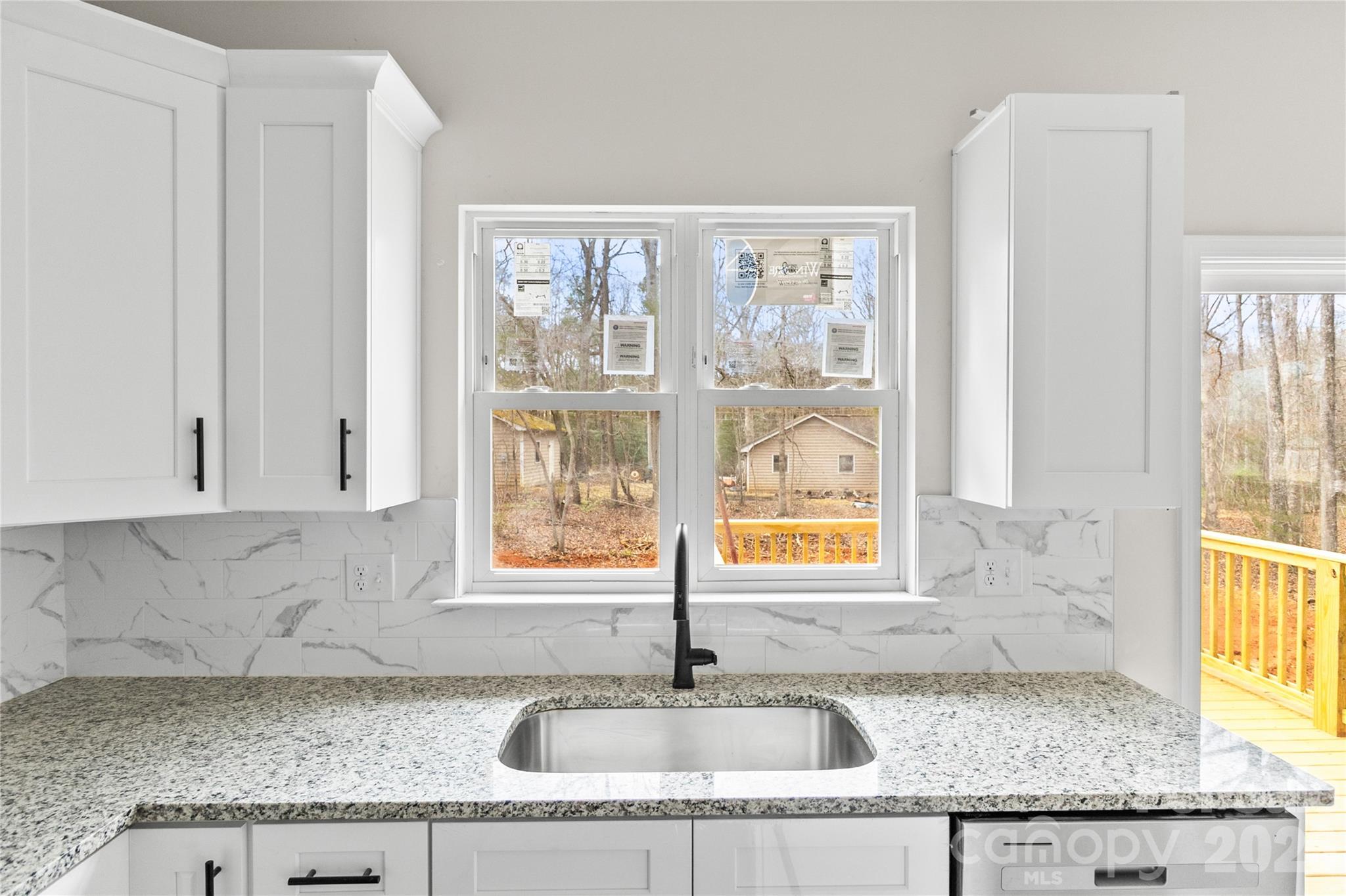 3692 Shannon Loop Denver, NC 28037 - Photo 5 of 47 a kitchen with granite countertop a sink and a window