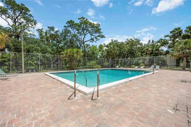 a view of a swimming pool with a yard