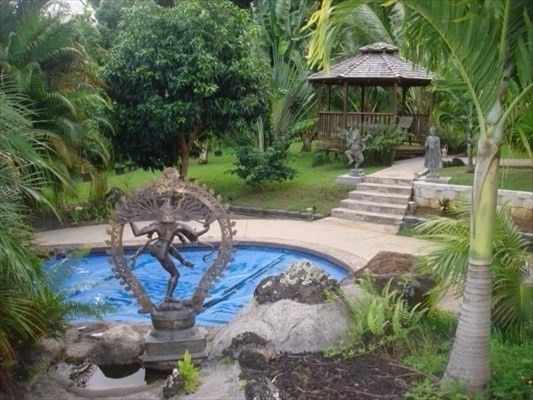 7158 Kahuna Road, Unit 2 Kapaa, HI 96746 - Photo 2 of 10 a view of backyard with a table and chairs under an umbrella